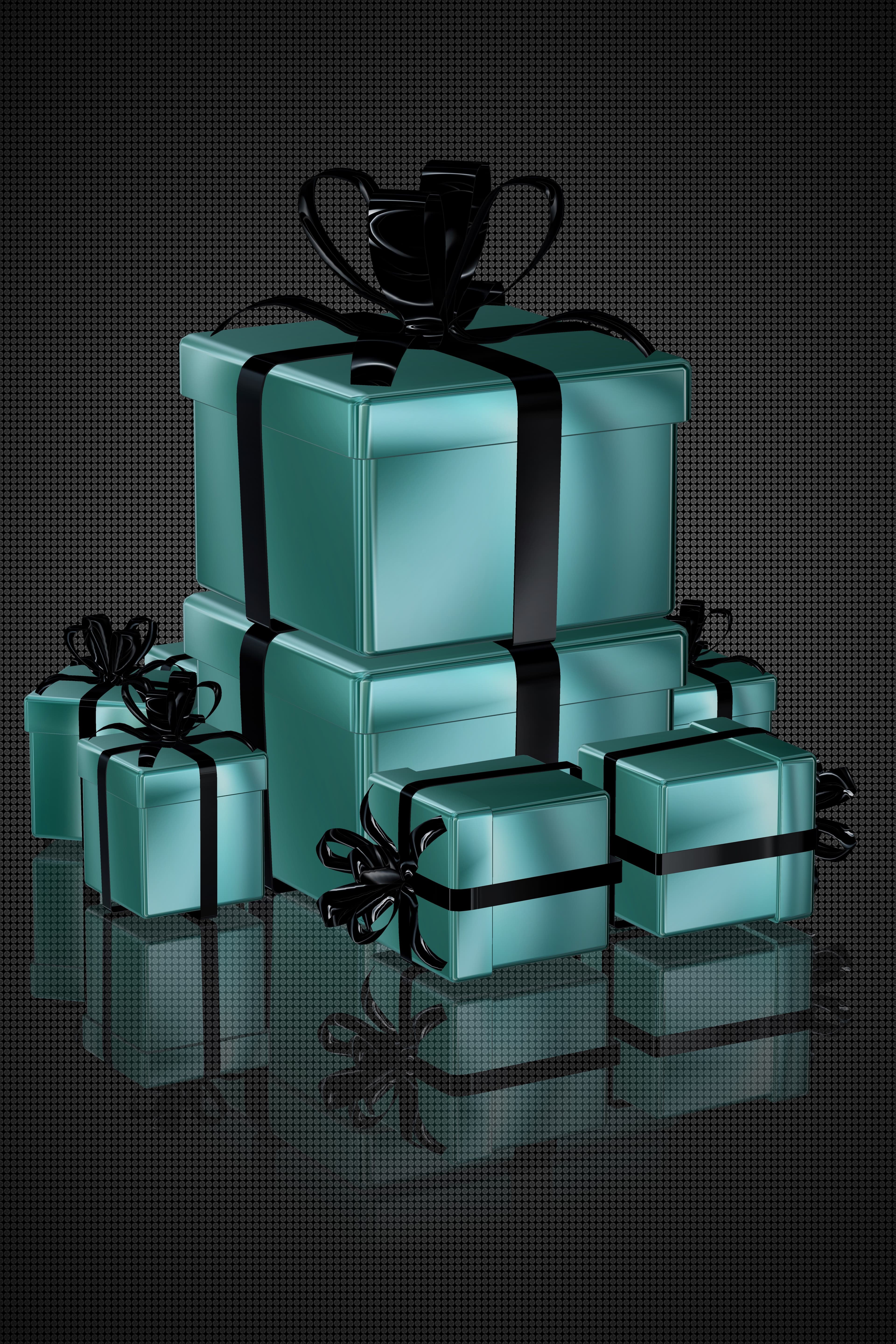 Stack of teal gift boxes tied with black ribbon
