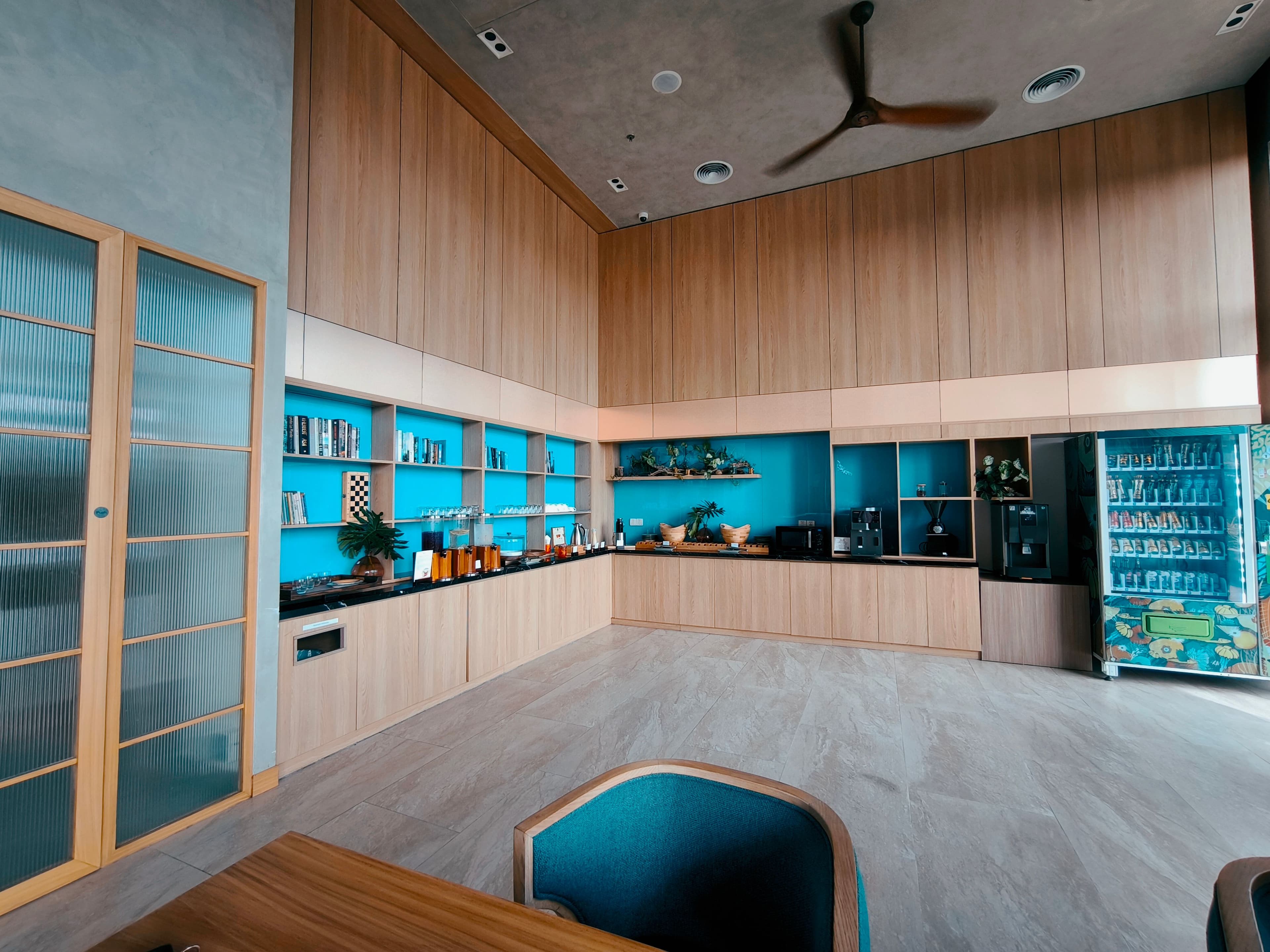 Modern office pantry with open shelving and a refreshment counter