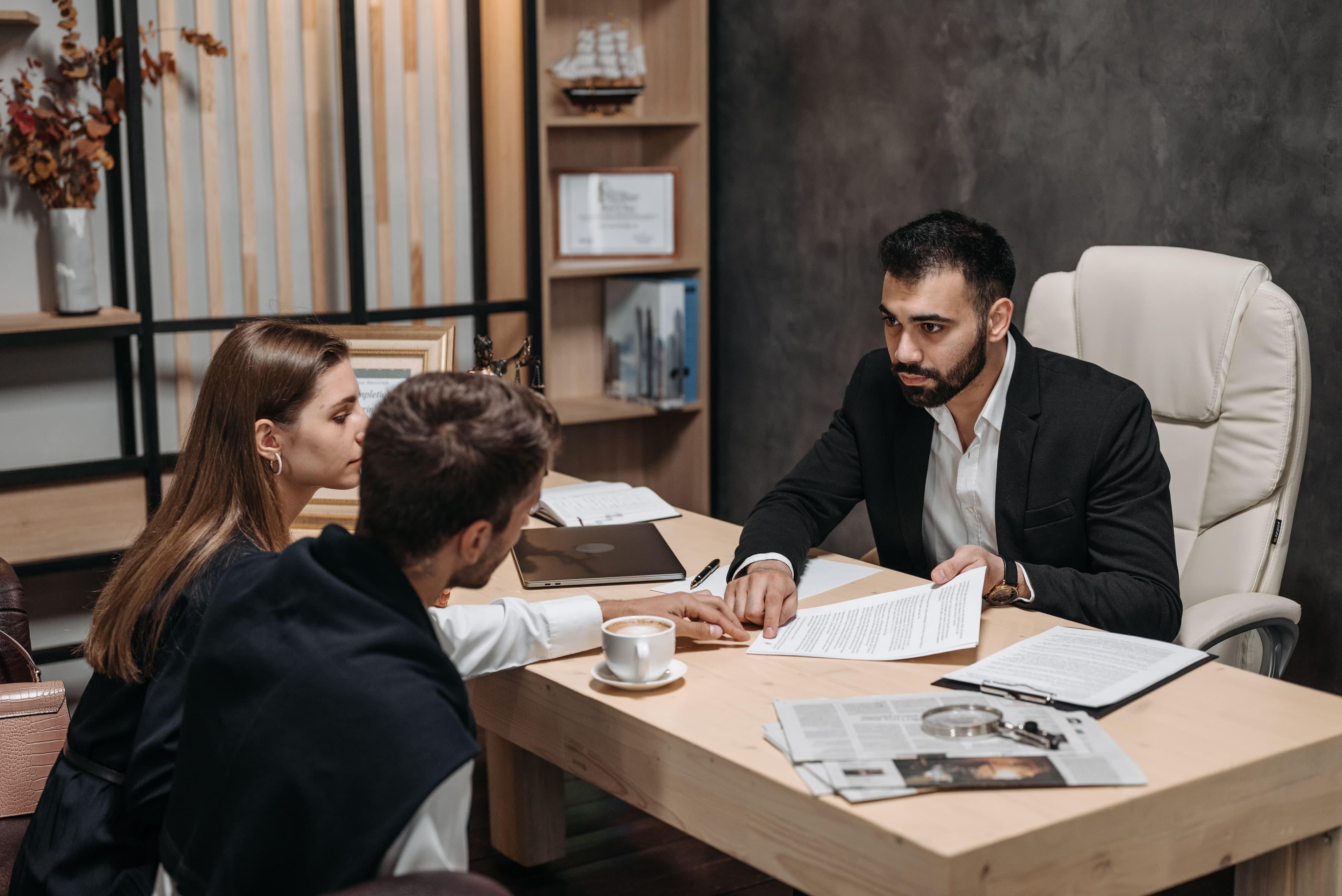 Consultation meeting around a desk in a well-appointed office